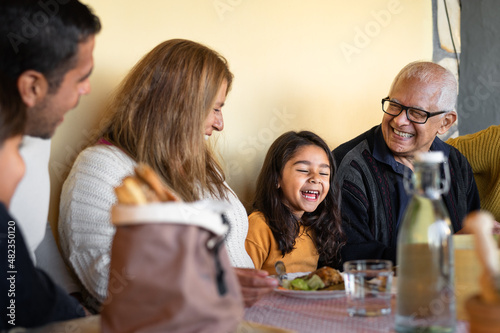 Happy Latin family having fun lunching together at home