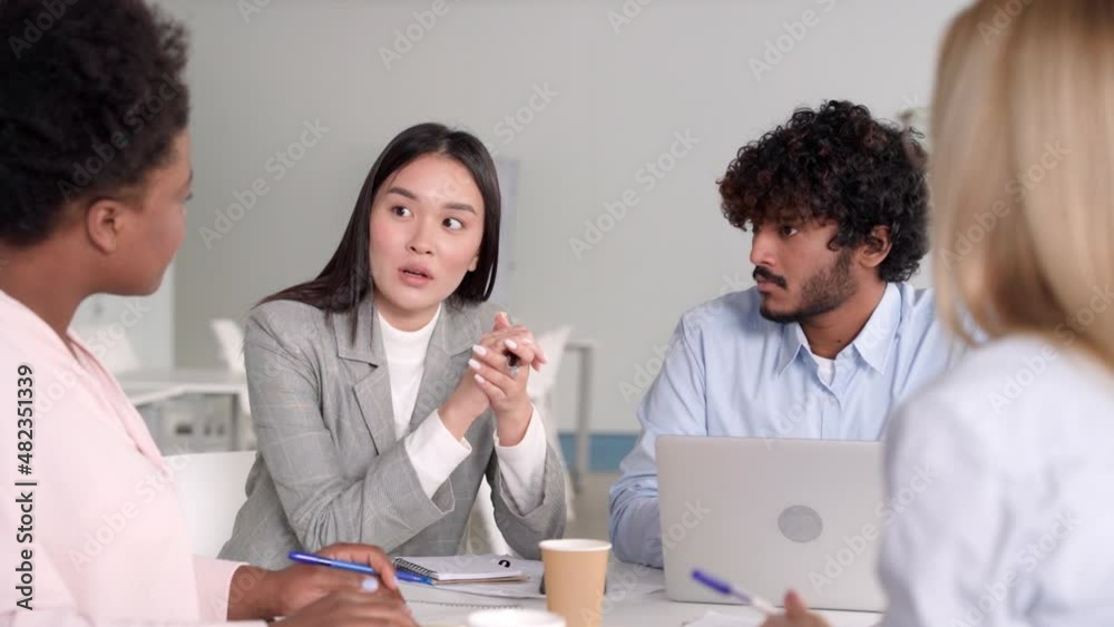 Young asian woman telling opinion speaking to multi-ethnic diverse colleagues Young asian woman telling opinion speaking to multi-ethnic diverse colleagues