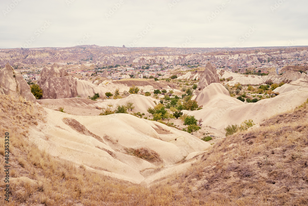 Travel and tourism in Turkey. Famous sightseeing Cappadocia, Anatolia. Beautiful landscape with mountains, caves and cloudy sky.