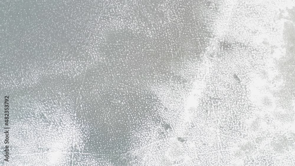 drone shot top view over a frozen lake. A different and interesting texture of the ice on the lake drone shot top view over a frozen lake. A different and interesting texture of the ice on the lake