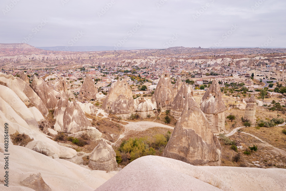 Travel and tourism in Turkey. Famous sightseeing Cappadocia, Anatolia. Beautiful landscape with mountains, caves and cloudy sky.