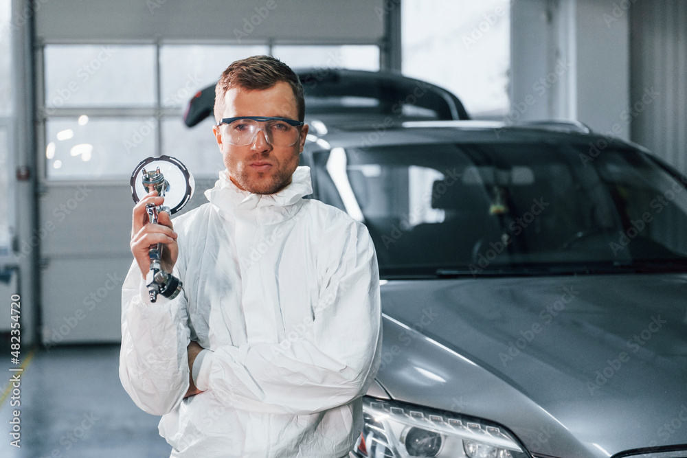 Fototapeta premium Job is done. Man in uniform is working in the auto service