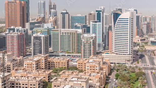 Skyscrapers in Barsha Heights district and low rise buildings in Greens district aerial timelapse. Dubai skyline