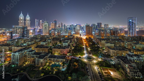 Skyscrapers in Barsha Heights district and low rise buildings in Greens district aerial all night timelapse. © neiezhmakov