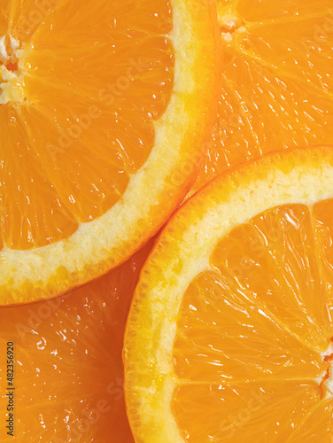 Slices of orange. Close up shot with beautiful colors and texture. Healthy food creative background design. Organic fruits. Flat lay minimal arrangement.