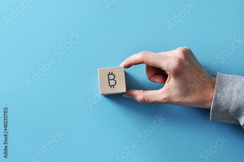 Bitcoin icon on a wooden cube