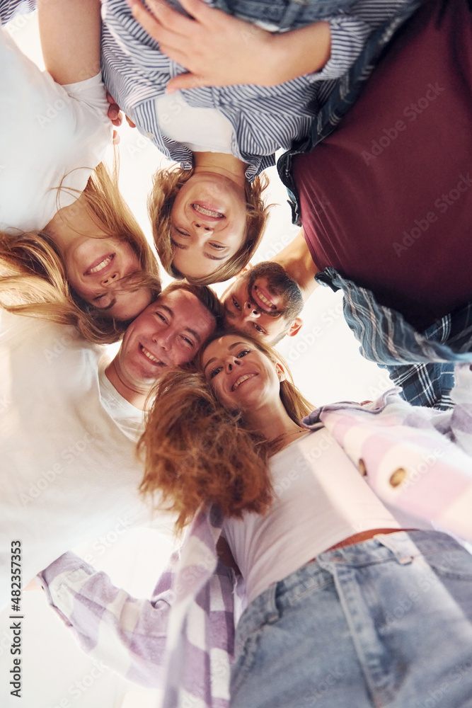 Looking down. Group of friends standing together Looking down. Group of friends standing together