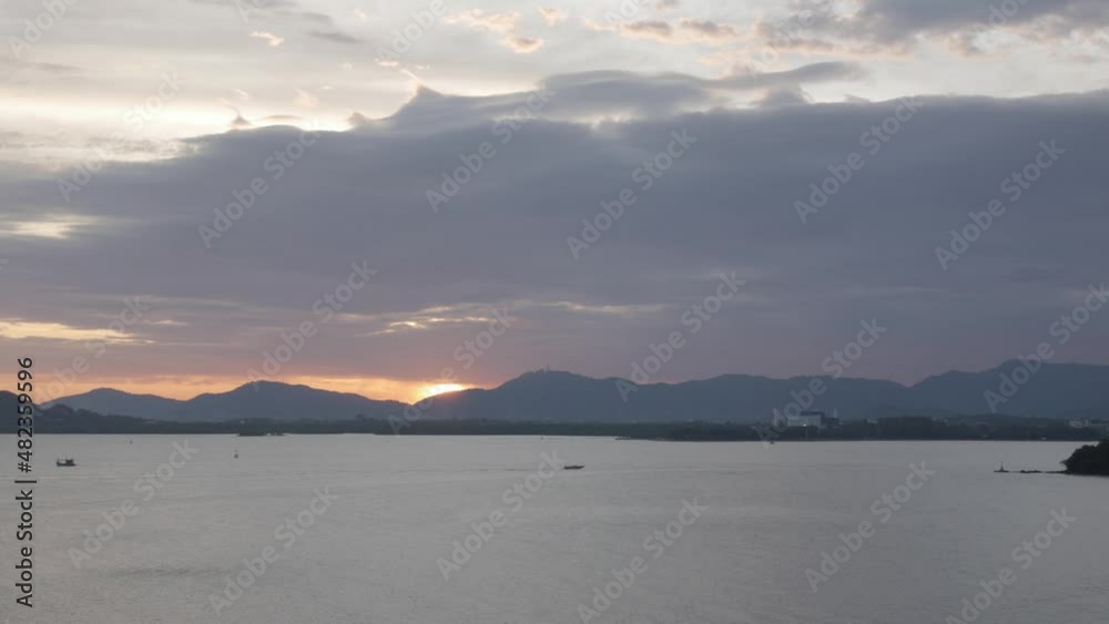 beautiful sunset view over the mountain range over the sea bay of phuket island in summer daytime beautiful sunset view over the mountain range over the sea bay of phuket island in summer daytime