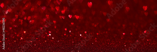 Red hearts, sparkling glitter bokeh background texture. Holiday valentines day lights. Abstract defocused header. Wide screen wallpaper. Panoramic web banner with copy space for design