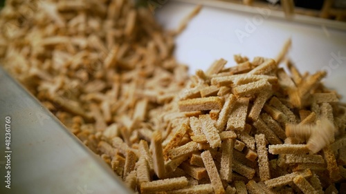 The process of making crackers. Cracker production. Croutons on the conveyor. Bread products on a conveyor line, in a food factory or in a factory with equipment.