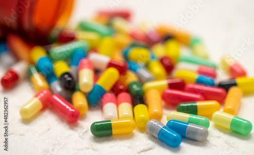 colorful capsule pills and bottle