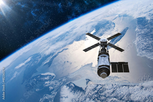 Fototapeta Naklejka Na Ścianę i Meble -  Cargo space craft Earth planet.Dark background. Sci-fi wallpaper.Space Station Orbiting Earth.Space ship.Space art wallpaper.Solar Observatory.Elements of this image furnished by NASA.3D illustration