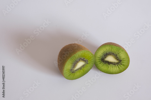 A kiwi cut in half to show its juicy flesh and beautiful green yellowish color