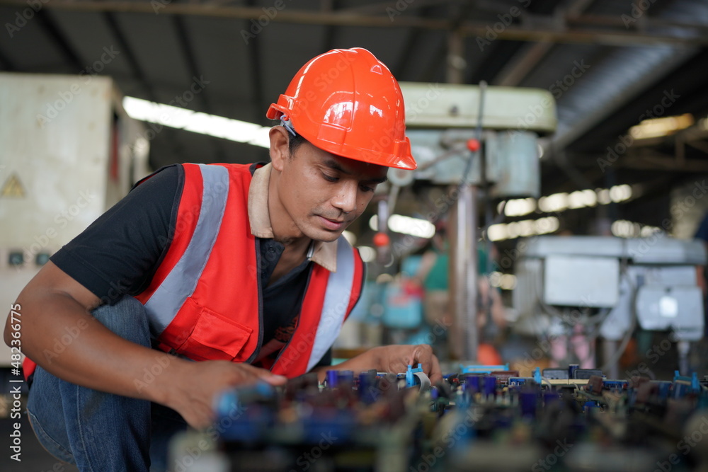 Professional engineer metalworker operating CNC milling machine center in manufacturing workshop Professional engineer metalworker operating CNC milling machine center in manufacturing workshop