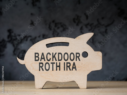 Wooden piggy bank with words backdoor Roth IRA. photo