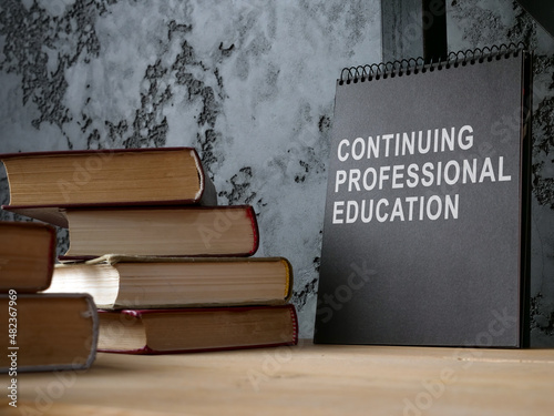 Photos Continuing professional education on the black notepad and books.
