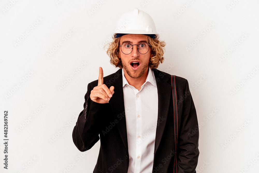 Young architect caucasian man with helmet isolated on white background having an idea, inspiration concept.