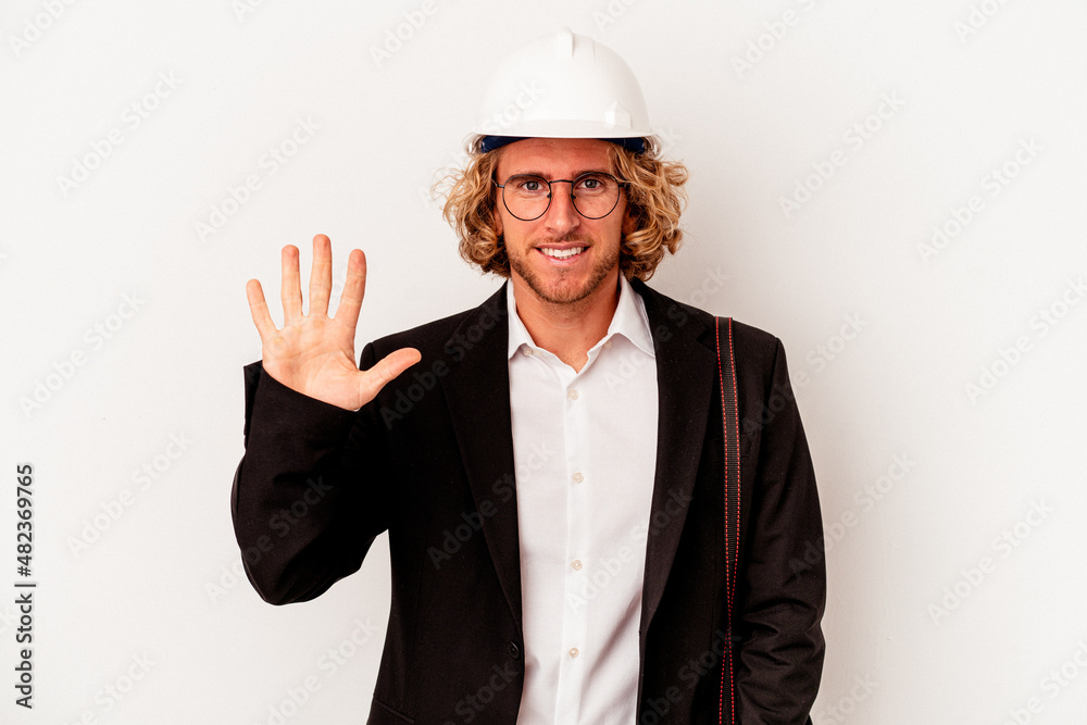 Young architect caucasian man with helmet isolated on white background smiling cheerful showing number five with fingers.