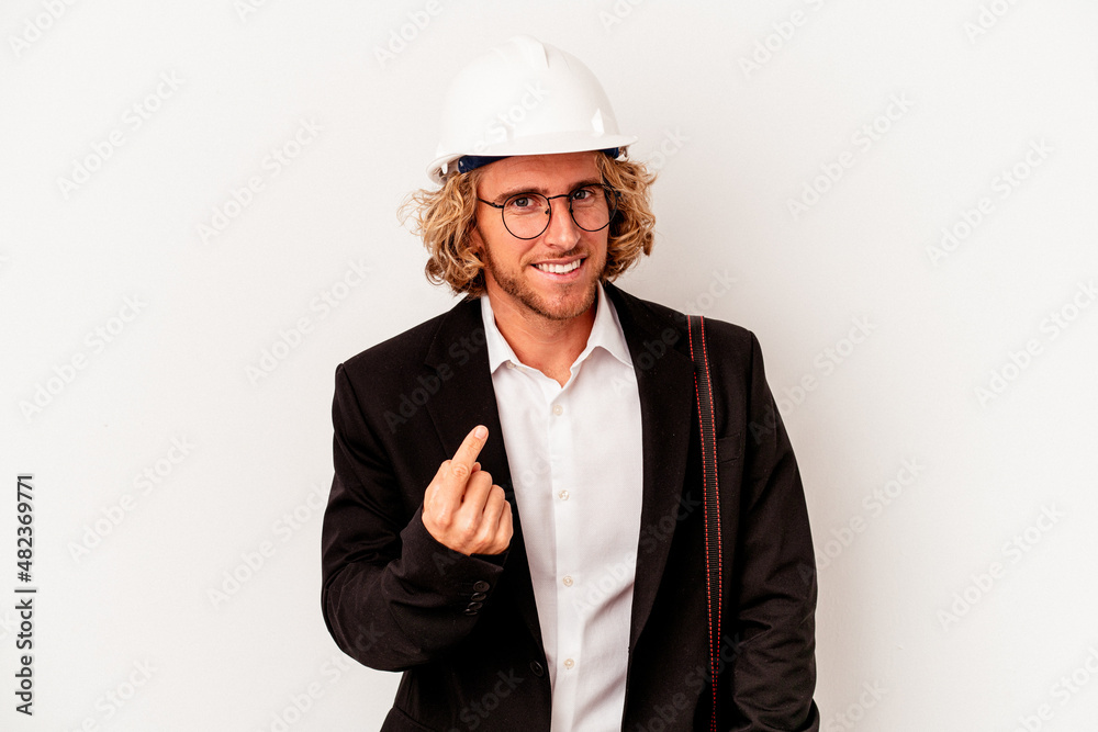 Young architect caucasian man with helmet isolated on white background pointing with finger at you as if inviting come closer. Young architect caucasian man with helmet isolated on white background pointing with finger at you as if inviting come closer.