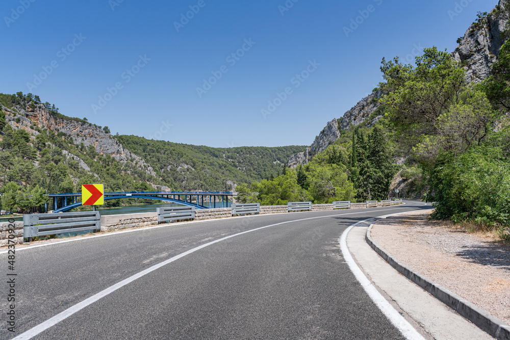 A road with sharp turns in the mountains. Serpentine highway. Skradin, Croatia. A road with sharp turns in the mountains. Serpentine highway. Skradin, Croatia.
