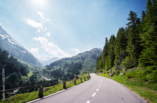 Asphalt road in Alp mountains. Road trip concept. Beautiful landscape.