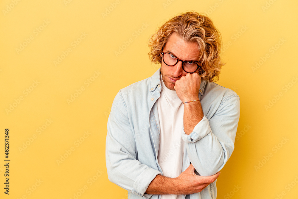 Young caucasian man isolated on yellow background who feels sad and pensive, looking at copy space. - obrazy, fototapety, plakaty 
