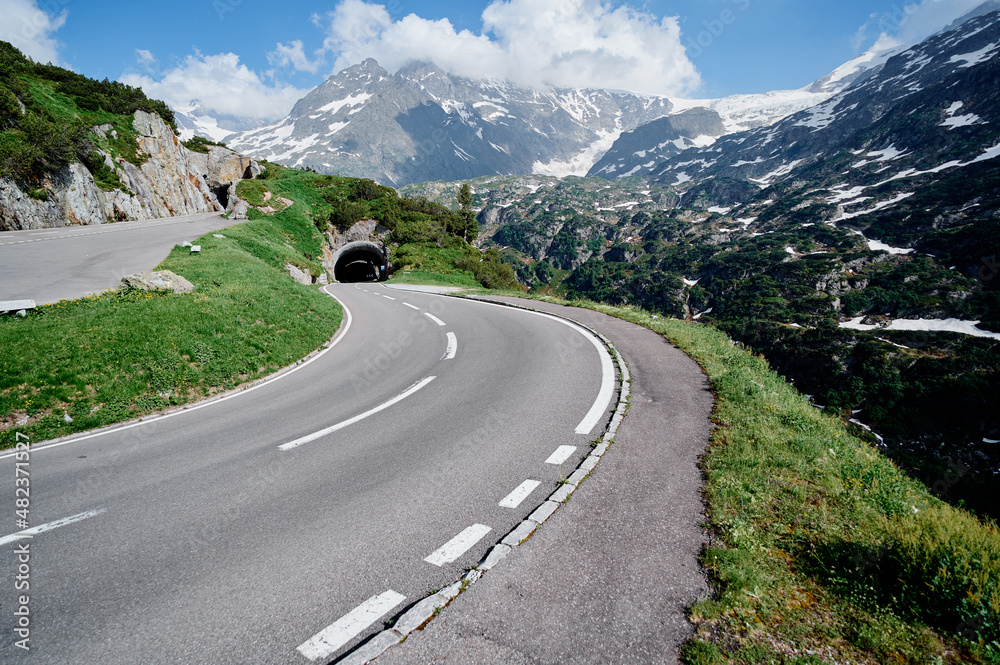 Naklejka premium Asphalt road in Alp mountains. Road trip concept. Beautiful landscape.