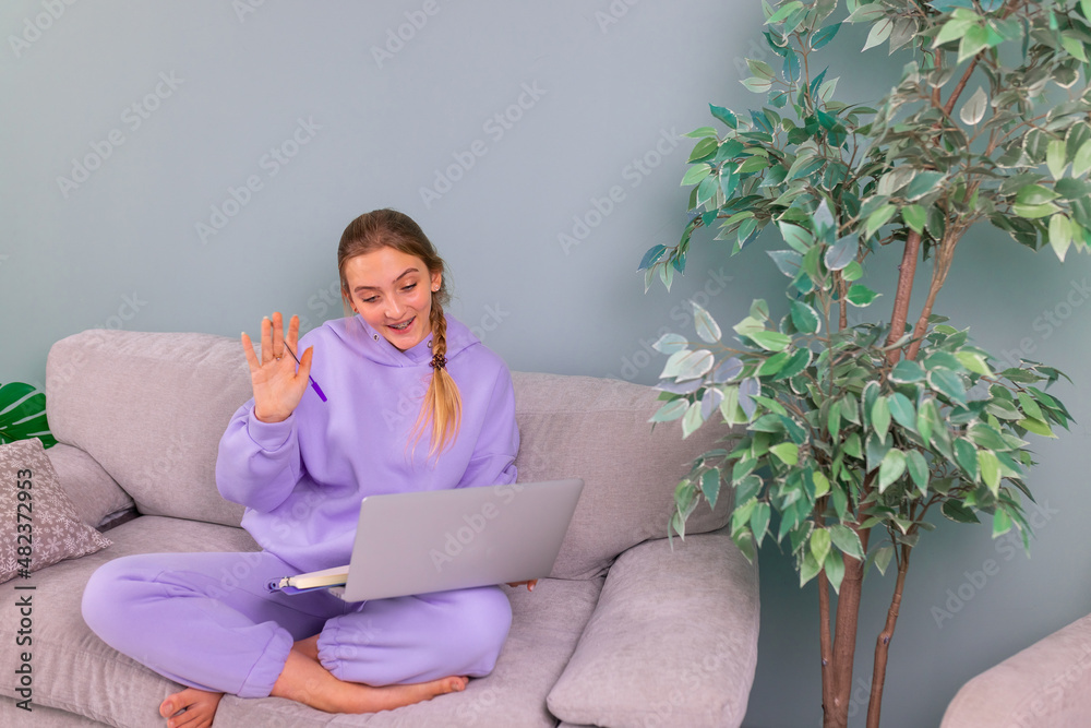 Happy smiling teenage girl student watching learning online video zoom class webinar in virtual classroom on her laptop. Happy smiling teenage girl student watching learning online video zoom class webinar in virtual classroom on her laptop.