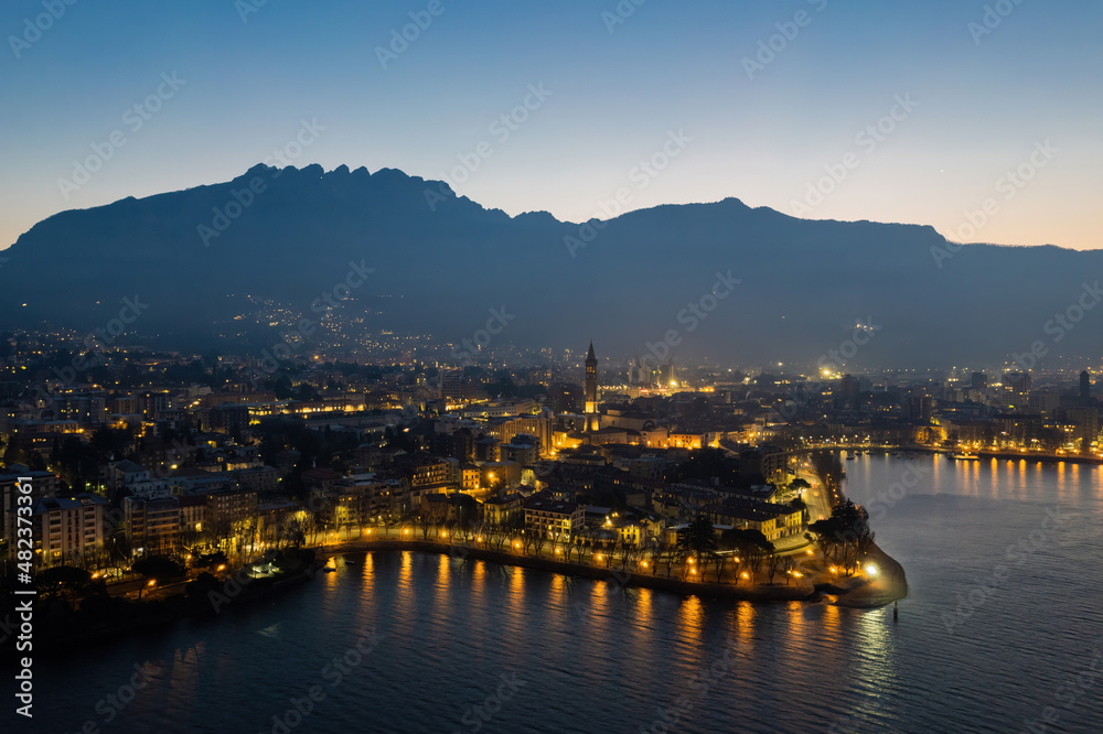 Lecco city aerial shot before the sunrise with Resegone mount on the background.
