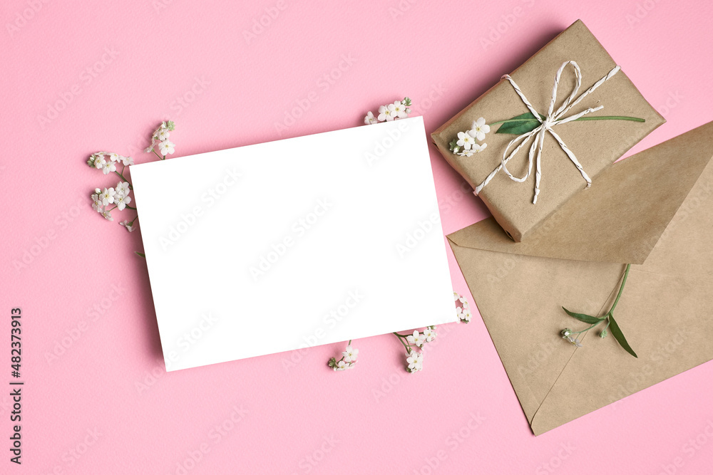 Greeting blank card mockup with gift box and flowers