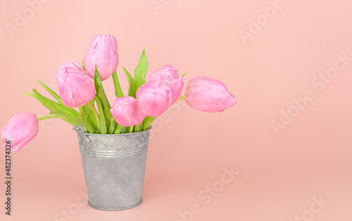 Fototapeta Naklejka Na Ścianę i Meble -  Bouquet of pink tulips in a rustic vase. Background for postcard