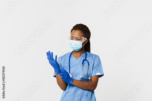 Black doctor wearing face mask posing with stethoscope