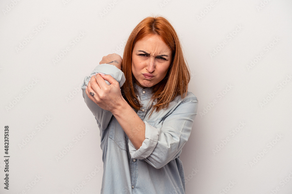 Young caucasian woman isolated on white background having a neck pain due to stress, massaging and touching it with hand. Young caucasian woman isolated on white background having a neck pain due to stress, massaging and touching it with hand.