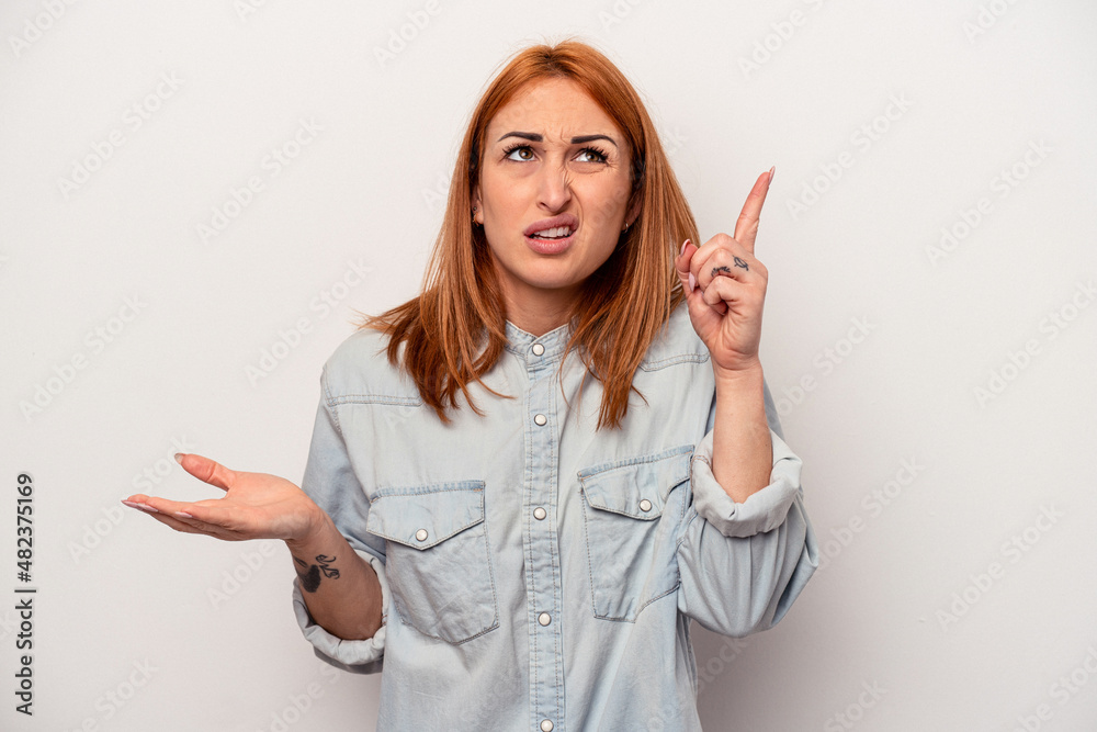 Young caucasian woman isolated on white background holding and showing a product on hand. Young caucasian woman isolated on white background holding and showing a product on hand.