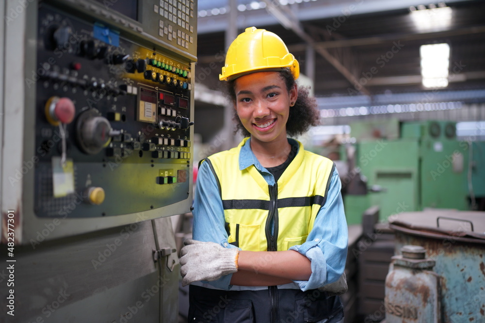Factory Female Industrial Engineer Works in metal working factory, Inside the Heavy Industry. Portrait of working female industry technical worker or engineer woman working in an industrial. Factory Female Industrial Engineer Works in metal working factory, Inside the Heavy Industry. Portrait of working female industry technical worker or engineer woman working in an industrial.