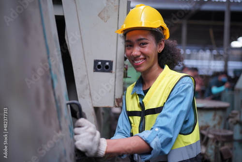 Female apprentice in metal working factory, Portrait of working female industry technical worker or engineer woman working in an industrial manufacturing factory company.