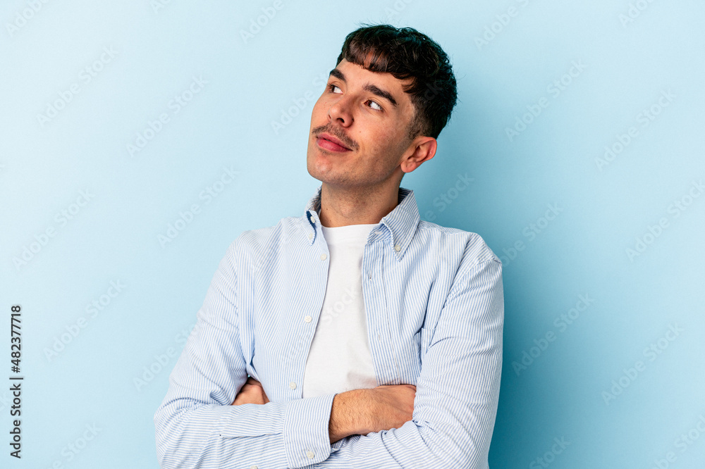 Young mixed race man isolated on blue background dreaming of achieving goals and purposes Young mixed race man isolated on blue background dreaming of achieving goals and purposes
