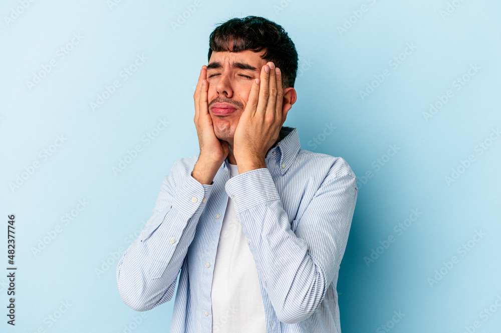 Young mixed race man isolated on blue background whining and crying disconsolately. Young mixed race man isolated on blue background whining and crying disconsolately.
