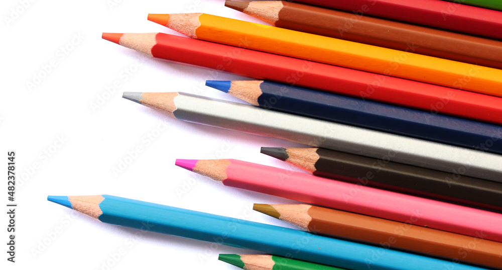 Colored pencils on white background, copy space Colored pencils on white background, copy space