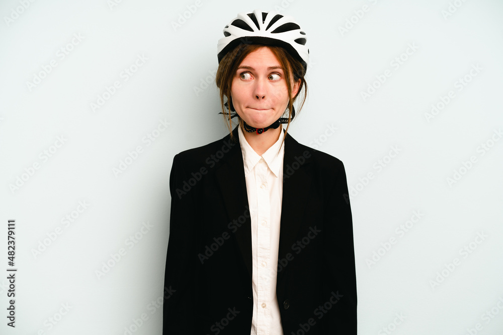 Young business English woman isolated on blue background confused, feels doubtful and unsure. Young business English woman isolated on blue background confused, feels doubtful and unsure.