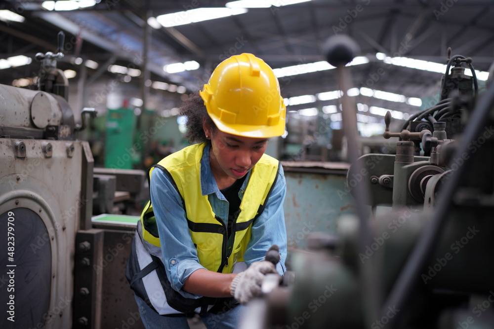 Female apprentice in metal working factory, Portrait of working female industry technical worker or engineer woman working in an industrial manufacturing factory company. Female apprentice in metal working factory, Portrait of working female industry technical worker or engineer woman working in an industrial manufacturing factory company.
