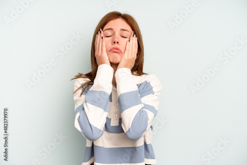 Fotografie Young English woman isolated on blue background whining and crying disconsolately