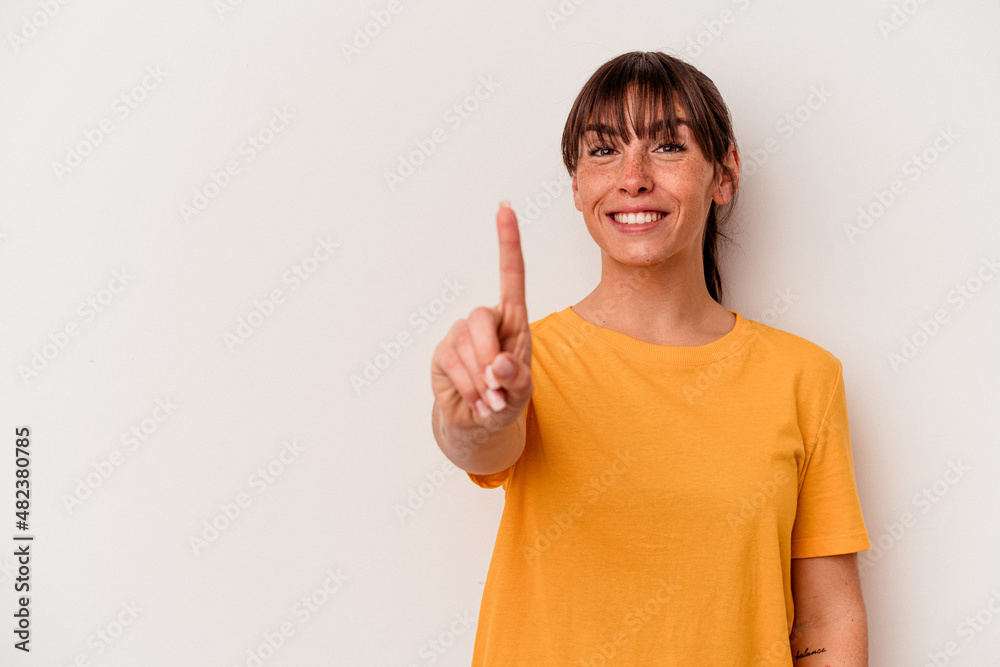 Young Argentinian woman isolated on white background showing number one with finger. Young Argentinian woman isolated on white background showing number one with finger.