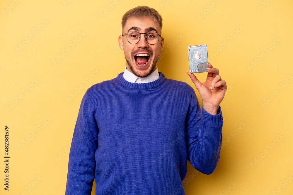 Young computer man isolated on yellow background Young computer man isolated on yellow background