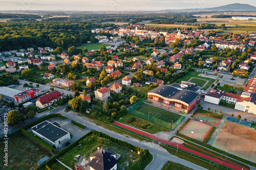 Fototapeta Naklejka Na Ścianę i Meble -  Aerial view of suburban neighborhood, Residential district with buildings and streets at small european town at sunset