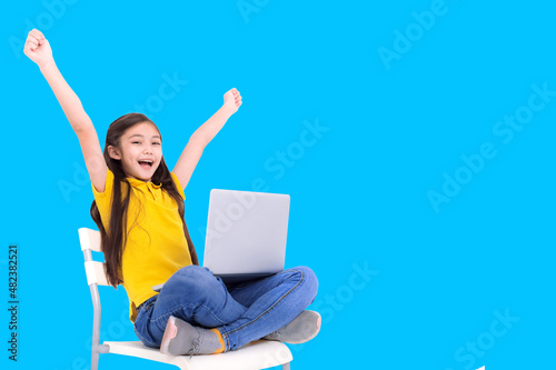 happy student girl holding laptop computer while sitting on the chair © Tom Wang