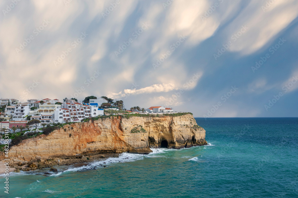 Townscape of Carvoeiro in the Algarve and rocky coastline Townscape of Carvoeiro in the Algarve and rocky coastline