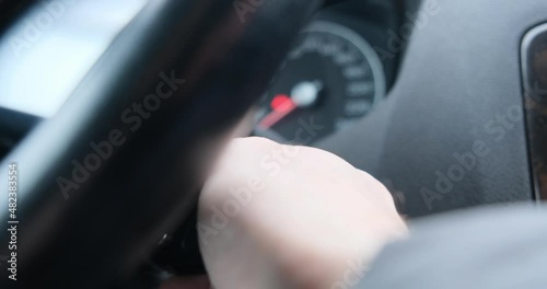 The man starts the car with the ignition key. Starting the engine. The concept of buying and selling a car, traffic rules, car service, driving school, auto instructor