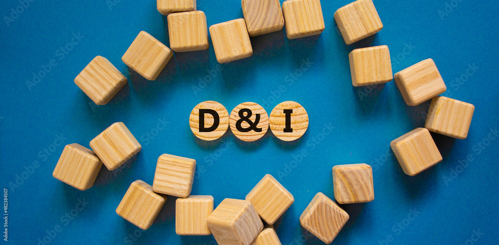 D and I, Diversity and inclusion symbol. Concept words D and I, diversity and inclusion on wooden circles on beautiful blue background. Business, D and I, diversity and inclusion concept.