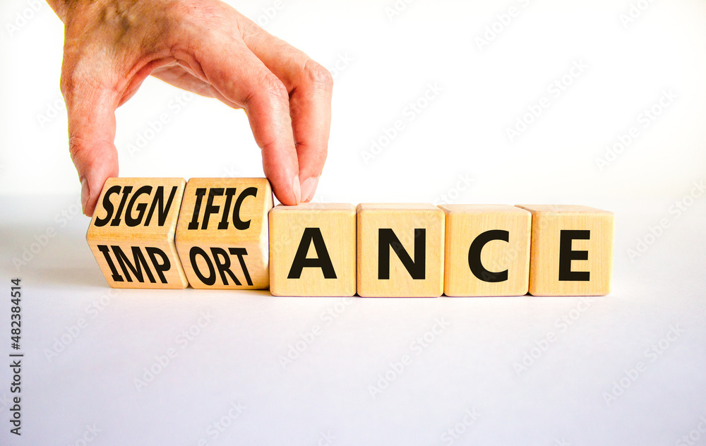Significance and importance symbol. Businessman turns cubes changes the